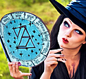 witch in a pointed hat looking at a tablet that contains the signs of the zodiac